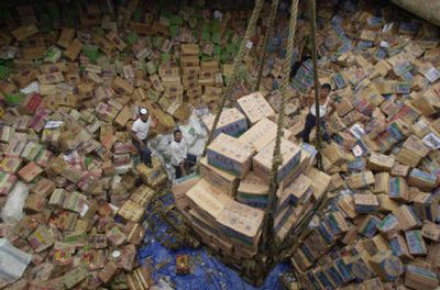 
Indonesian navy sailors load boxes of aid bound for tsunami victims in Banda Aceh into a container ship in this January, 2005, photo taken in Jakarta, Indonesia. 
 (File/Associated Press / The Spokesman-Review)