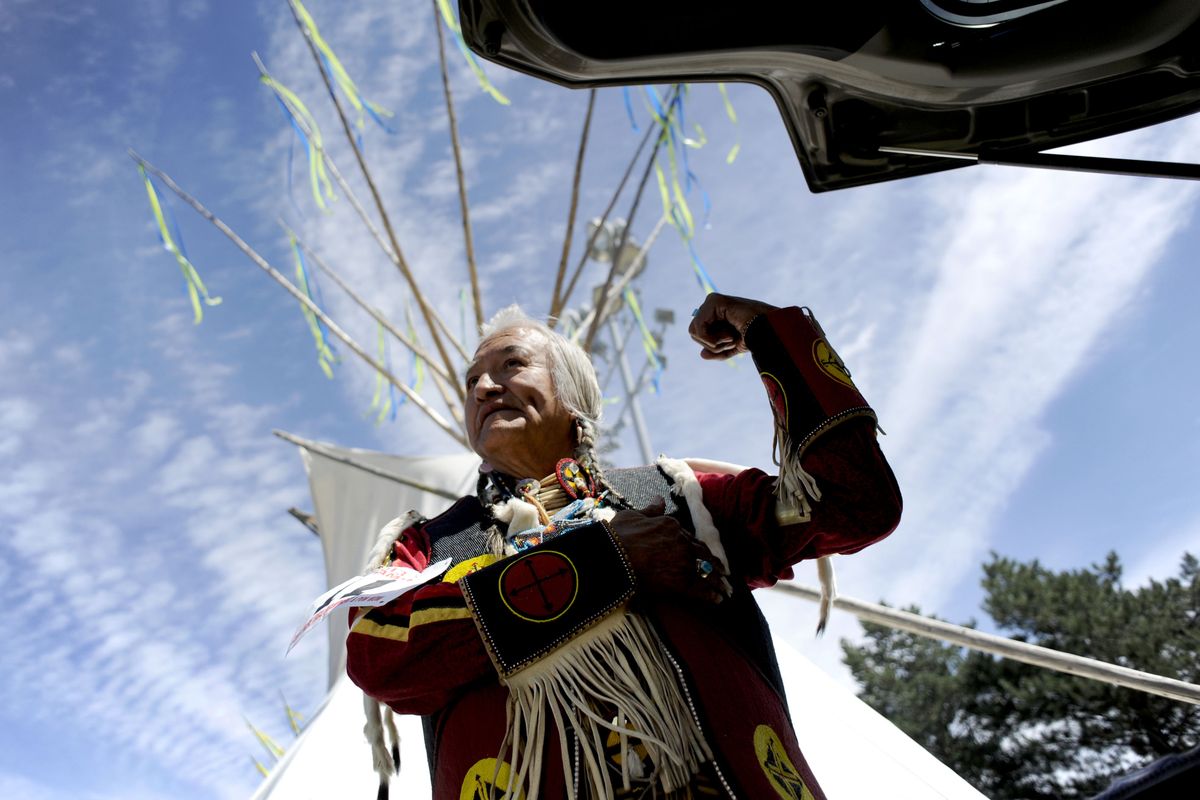 Pend Oreille Salish elder Stephen Small Salmon, of Ronan, Mont., shows off his muscles as he prepares for the Grand Entry for Julyamsh Powwow in Post Falls on Saturday. The Coeur d’Alene Tribe has hosted the four-day celebration for the past 18 years. (Kathy Plonka)