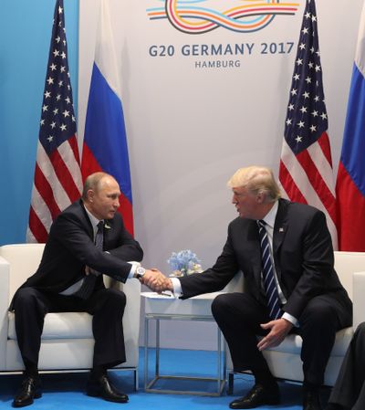 U.S. President Donald Trump, right, and Russian President Vladimir Putin shake hands during the G20 summit in Hamburg Germany today. Trump's approach to foreign policy has been criticized. (Mikhail Klimentyev, Kremlin Pool Photo via AP)