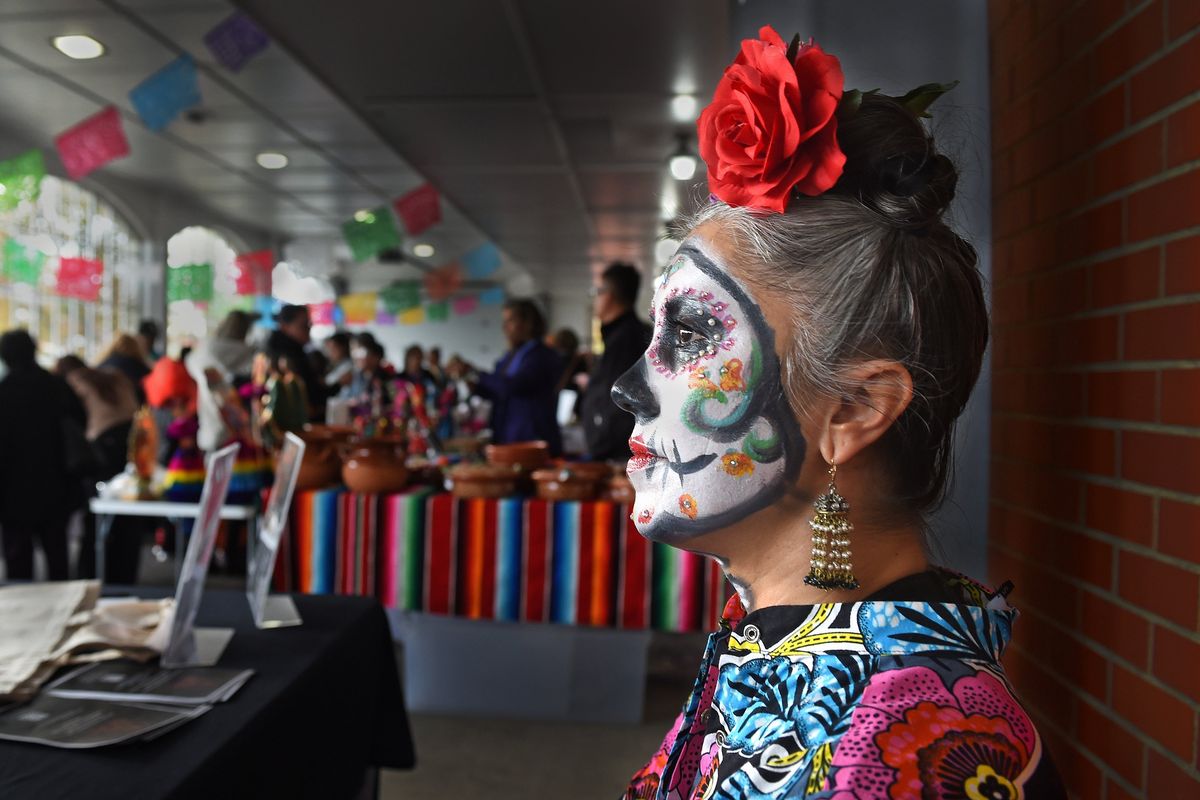 Camerina Zorrozua of Spokane waits to help people at her Way to Justice booth Sunday at the Eighth Annual Dia de los Muertos celebration in Spokane Valley. Hazen & Jaeger Valley Funeral Home and the Hispanic Business Association teamed up to present a day to celebrate Mexican culture.  (Christopher Anderson/For The Spokesman-Review)