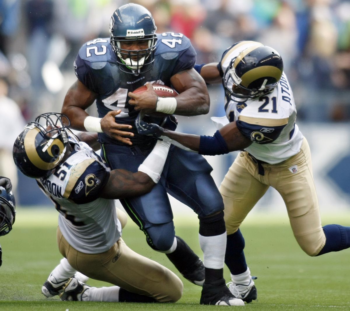 Associated Press St. Louis’ Will Witherspoon, left, and O.J. Atogwe attempt to bring down Seattle’s T.J. Duckett during the fourth quarter. (Associated Press / The Spokesman-Review)