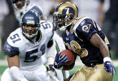 
Rams'  Marshall Faulk ran through Seattle's defense for 139 yards. 
 (Associated Press / The Spokesman-Review)