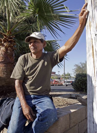Dionisio Urbina, an undocumented laborer from Honduras, waits Thursday at a labor pickup site in San Diego hoping for a day job. (Associated Press / The Spokesman-Review)