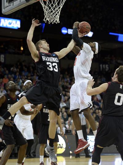 Harvard's Evan Cummins tries to stop Cincinnati's Titus Rubles, right, Thursday, Mar. 20, 2014 at the Spokane Veterans Memorial Arena.  Harvard prevailed 61-57 over the Bearcats in the second round of the 2014 NCAA Division I Men's Basketball Championships in Spokane. (The Spokesman-Review)