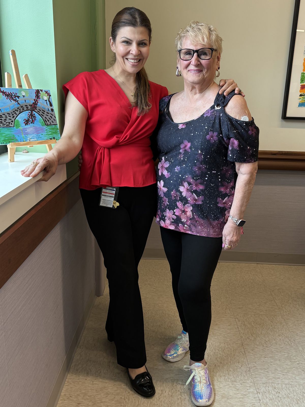 Roberta Rabinovitz (right), with Rachel Nassif, day center director at the PACE Organization of Rhode Island, based in East Providence. PACE helped find a studio apartment in an assisted living facility for Rabinovitz as part of its efforts to keep her healthy and out of a pricey nursing home. (Felice J. Freyer/KFF Health News/TNS)