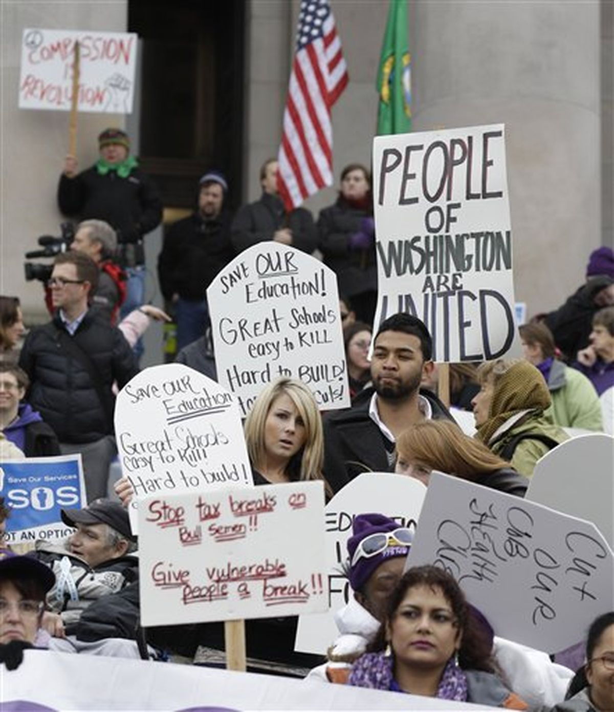 Protesters demonstrate against budget cuts outside the Capitol in Olympia on Monday, on the first day of a special 30-day session of the Washington state Legislature focused on addressing the state