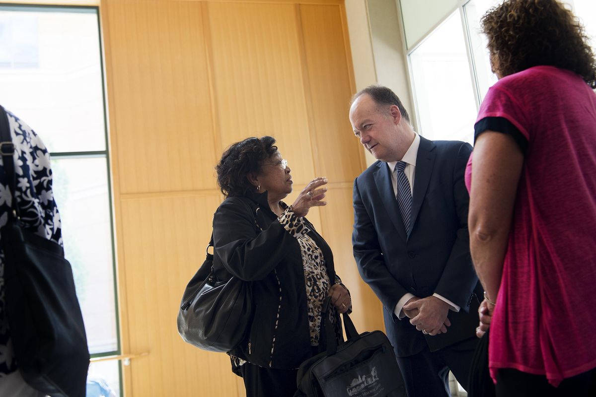 Patricia Bayonne-Johnson, the descendant of a slave family sold by Georgetown University in the 1830s to settle debts speaks with Georgetown University President John J. DeGioia on Monday, June 13, 2016, at Spokane Public Library in Spokane, Wash. (Tyler Tjomsland / The Spokesman-Review)