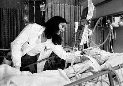 
This photo of Dr. Elisabeth Hagen caring for an elderly patient on life support at North Shore University Hospital in Manhasset, New York, is among photos included in the new book 