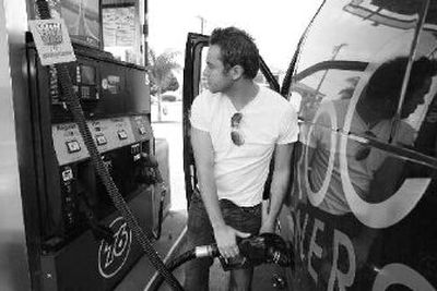 
Justin Smith fills up his van at a gas station in west Los Angeles on Monday. 
 (Associated Press / The Spokesman-Review)