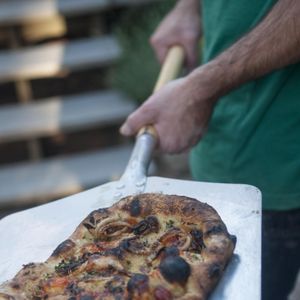 Shaun Thompson Duffy removes freshly wood-fired pizza from the Patanos' outdoor oven. ADRIANA JANOVICH adrianaj@spokesman.com (Adriana Janovich / The Spokesman-Review)