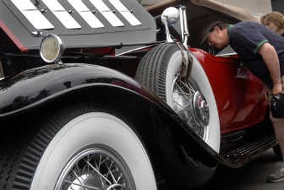 Rick Dullanty, of Spokane, gazes at a 1931 Cadillac convertible owned by Harry and Marcia Mielke at the Car d'Lane Classic Car Show  on Saturday. 
 (Photos by Holly Pickett / The Spokesman-Review)