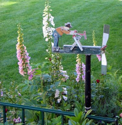 
Hand-made garden ornaments, like this Sawing Man whirligig add interest and fancy to any flowerbed. 
 (Cheryl-Anne Millsap / The Spokesman-Review)