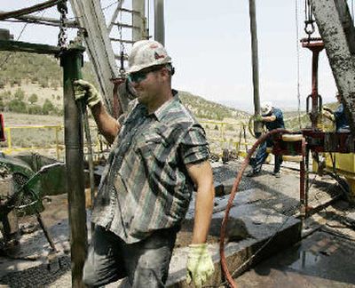 
 Brian Barclay, left, works on a gas drilling rig in Rifle, Colo. Barclay makes a 275-mile commute across Colorado to work there. 
 (The Spokesman-Review)