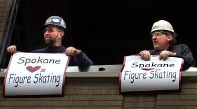 Carpenters Steve Lutzke, left, and Bartom Frietag look down on Post Street during a surprise rally Monday for the U.S. Figure Skating site selection team.
(photos by Holly Pickett / The Spokesman-Review)