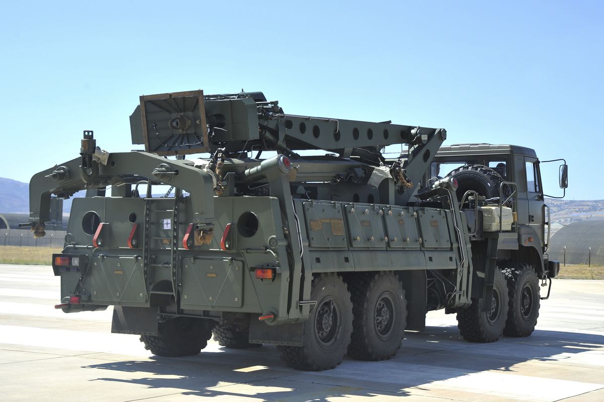 FILE - In this Tuesday, Aug. 27, 2019 file photo, a truck carrying parts of the S-400 air defense systems, exits a Russian transport aircraft after landing at Murted military airport outside Ankara, Turkey. The Trump administration is imposing sanctions on its NATO ally Turkey over its purchase of a Russian air defense system. The move comes at a delicate time in relations between Washington and Ankara. The countries have been at odds over Turkey