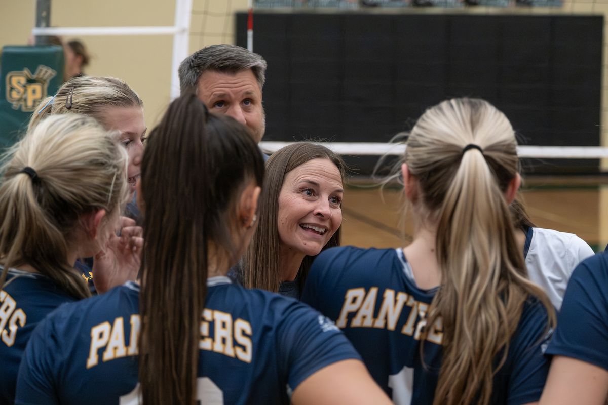First-year Mead volleyball coach Karrie Delp, facing, talks to her team after the first set against Shadle Park on Tuesday, October. 28, 2025, at Shadle Park High School in Spokane, Washington.  (Madison McCord/For The Spokesman-Review)
