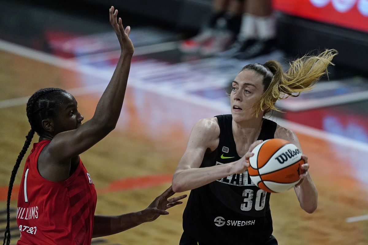 Seattle Storm forward Breanna Stewart, right, tries to pass as after the Atlanta Dream center/forward Elizabeth Williams, left, defends during the first half of their WNBA basketball game Wednesday, June 9, 2021, in College Park, Ga.  (Associated Press)