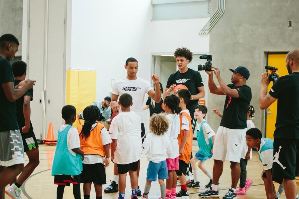 Gonzaga guard Nolah Hickman, middle left, talks with children at his annual basketball camp in his hometown of Seattle. Hickman, with help from family, turned the camp into The Give Back Foundation, which intends to transform the health and wellness of the local youth.  (Courtesy The Give Back)