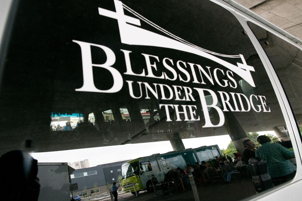 The Molina mobile health care unit is seen reflected in the rear window of a Blessings Under the Bridge van at Blessings Under the Bridge on Wednesday, Aug. 29, 2018, in Spokane, Wash. (Tyler Tjomsland / The Spokesman-Review)