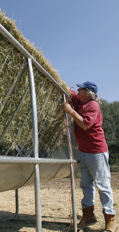Rancher Don Davis prepares hay for his cattle near Tarpley, Texas, on Thursday. Severe drought in Texas and the southern Plains has crippled hay production. (Associated Press)
