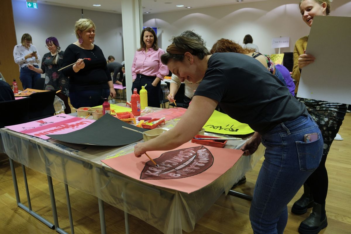 Women make signs ahead of demonstrations on Monday in Reykjavik, Iceland.  (Ragnhildur Sigurdottir/Bloomberg)