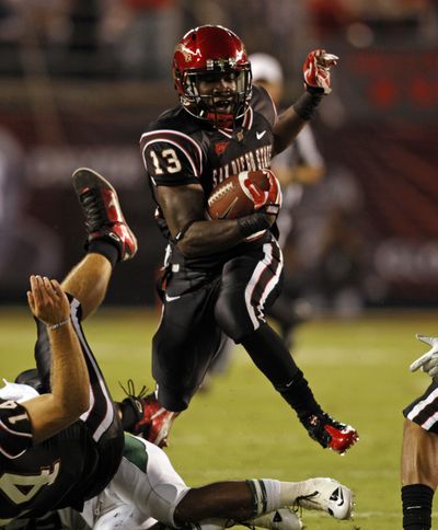 San Diego State running back Ronnie Hillman scoots through a hole against Cal Poly in Aztecs’ opener. (Associated Press)