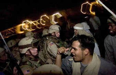 
Capt. Kory Turnbow, 28, and Spc. Rocky Parker, 27 encounter opposition forces, who show their displeasure at the guardsmen from the 116th Combat Engineers who entered their village. Colin Mulvany / 
 (The Spokesman-Review)