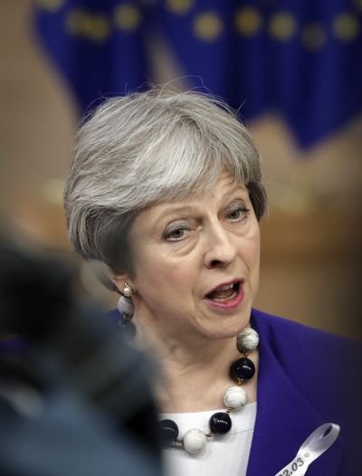 British Prime Minister Theresa May speaks with the media as she arrives for an EU summit at the Europa building in Brussels on Thursday, March 22, 2018. (Olivier Matthys / Associated Press)