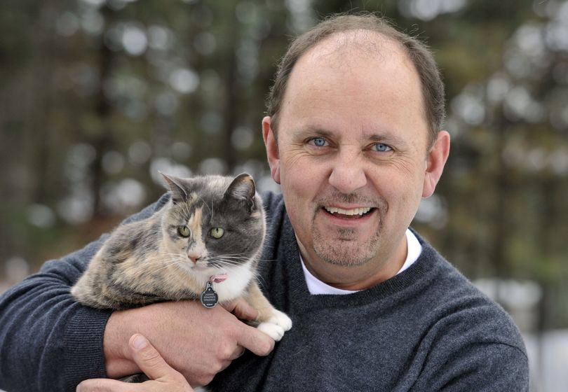 Bill Jones and  his cat, Jasmine, are reunited at home after she was missing for 10 days.  (Dan Pelle)