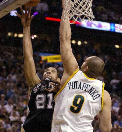 
Spurs' Tim Duncan puts up the winning shot over SuperSonics' Vitaly Potapenko with half a second left to give San Antonio a series-clinching victory.
 (Associated Press / The Spokesman-Review)