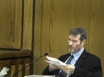 Kevin Coe reads from previous trial testimony while on the witness stand in Superior Court  on Tuesday.  (CHRISTOPHER ANDERSON / The Spokesman-Review)