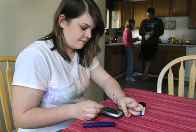 Taylor Duncan, of Spokane, tests her blood sugar and plans to record the results in an online system called Microsoft HealthVault. (Dan Pelle / The Spokesman-Review)