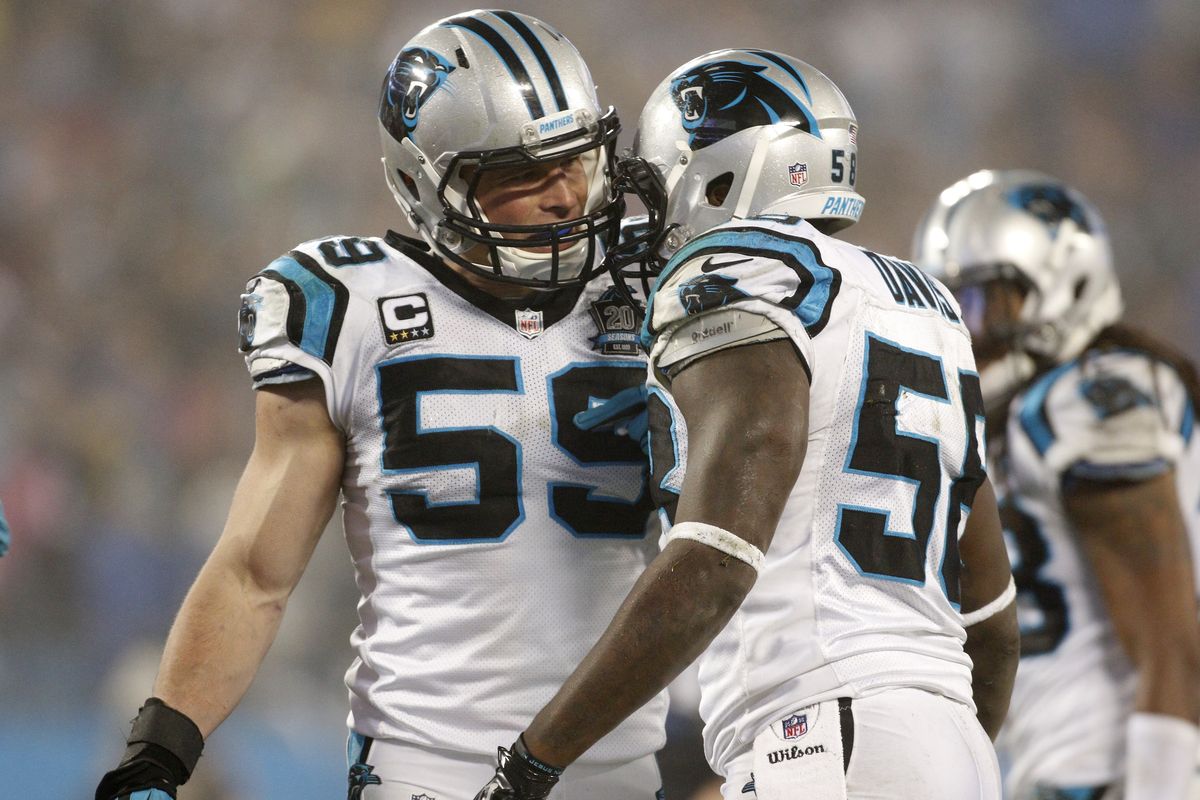 Luke Kuechly, left, consults with fellow Carolina Panthers linebacker Thomas Davis in the second half of Saturday’s win over Arizona. (Associated Press)