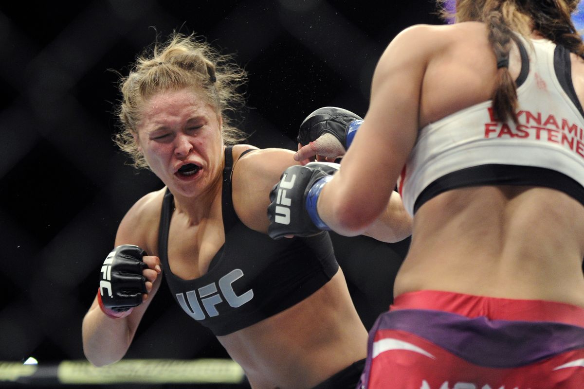 Ronda Rousey, left, punches Miesha Tate during the UFC 168 in 2013. Rousey will fight Brazilian Bethe Correia on Saturday. (Associated Press)