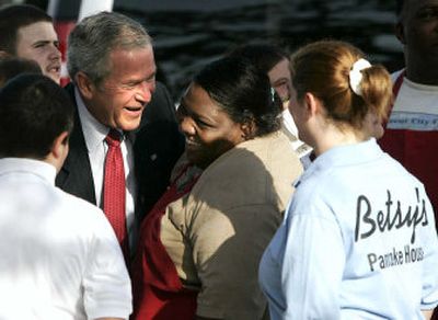 
President Bush talks to workers of Betsy's Pancake House in New Orleans after having breakfast with Mayor Ray Nagin on Tuesday, part of a visit to mark the one year anniversary of Hurricane Katrina.
 (Associated Press / The Spokesman-Review)