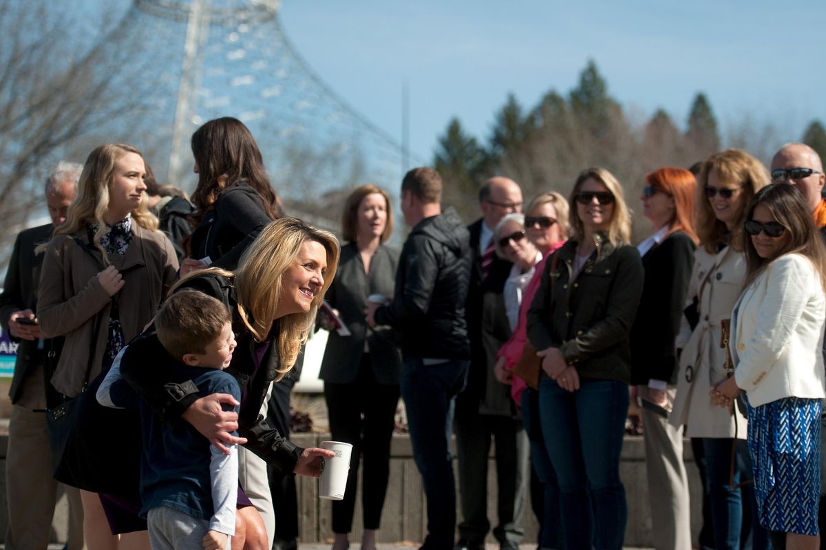 Nadine Woodward poses for a photograph with Patrick Hickey, 6, before announcing her run for mayor of Spokane on Tuesday, April 2, 2019. (Kathy Plonka / The Spokesman-Review)