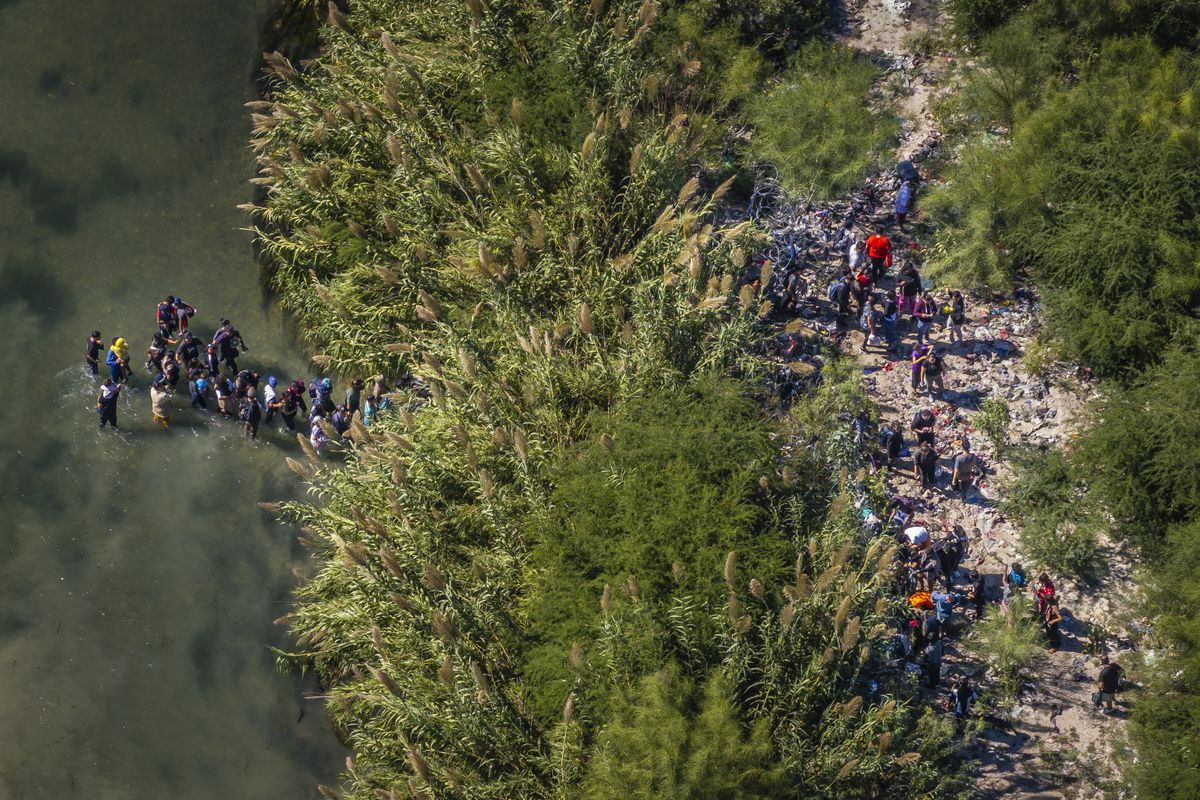 At Eagle Pass, Texas, migrants cross the Rio Grande from Mexico to the United States in late September.  (Jabin Botsford/Washington Post)