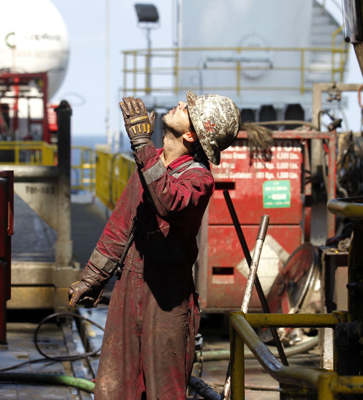 Bobby Moseley looks up from the drilling floor at drilling pipe being removed on the Development Driller III, which pumped the cement to seal the Macondo well off the coast of Louisiana on Saturday.