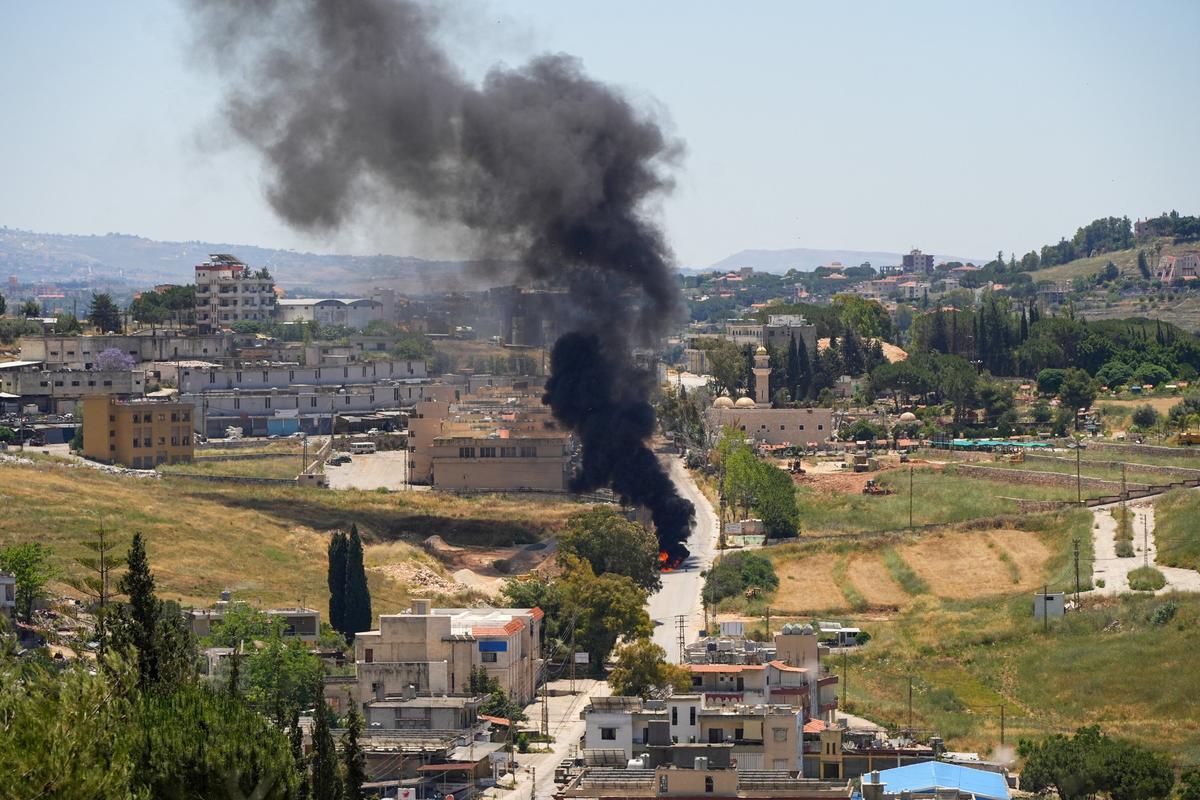 Black smoke billows at a strike scene Friday following an Israeli strike on a car as seen from Nabatieh, Lebanon. (Reuters)