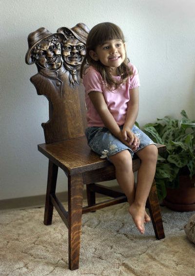 
Valerie De Ryan sits in her grandmother's (Sarah De Ryan) antique chair. The chair is from the 1890s and came from Minnesota. Sarah aquired it from her grandmother. 
 (Dan Pelle / The Spokesman-Review)