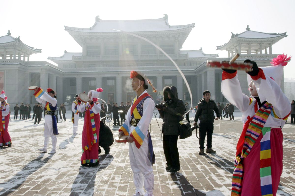 North Korean youths in traditional Korean outfit play instruments in front of the Pyongyang Grand Theatre in Pyongyang, North Korea, to celebrate a rocket launch on Wednesday, Dec. 12, 2012. North Korea appeared to successfully fire a long-range rocket Wednesday, defying international warnings as the regime of Kim Jong Un pushes forward with its quest to develop the technology needed to deliver a nuclear warhead. (Jon Jin / Associated Press)