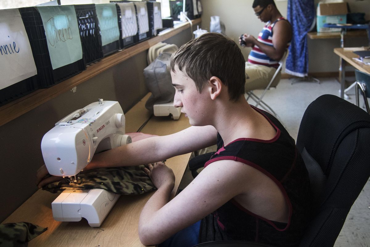 Excelsior client Jakeob, front, and Dexter, rear, work on sewing projects July 13, 2017 in the youth center’s craft room. (Dan Pelle / The Spokesman-Review)