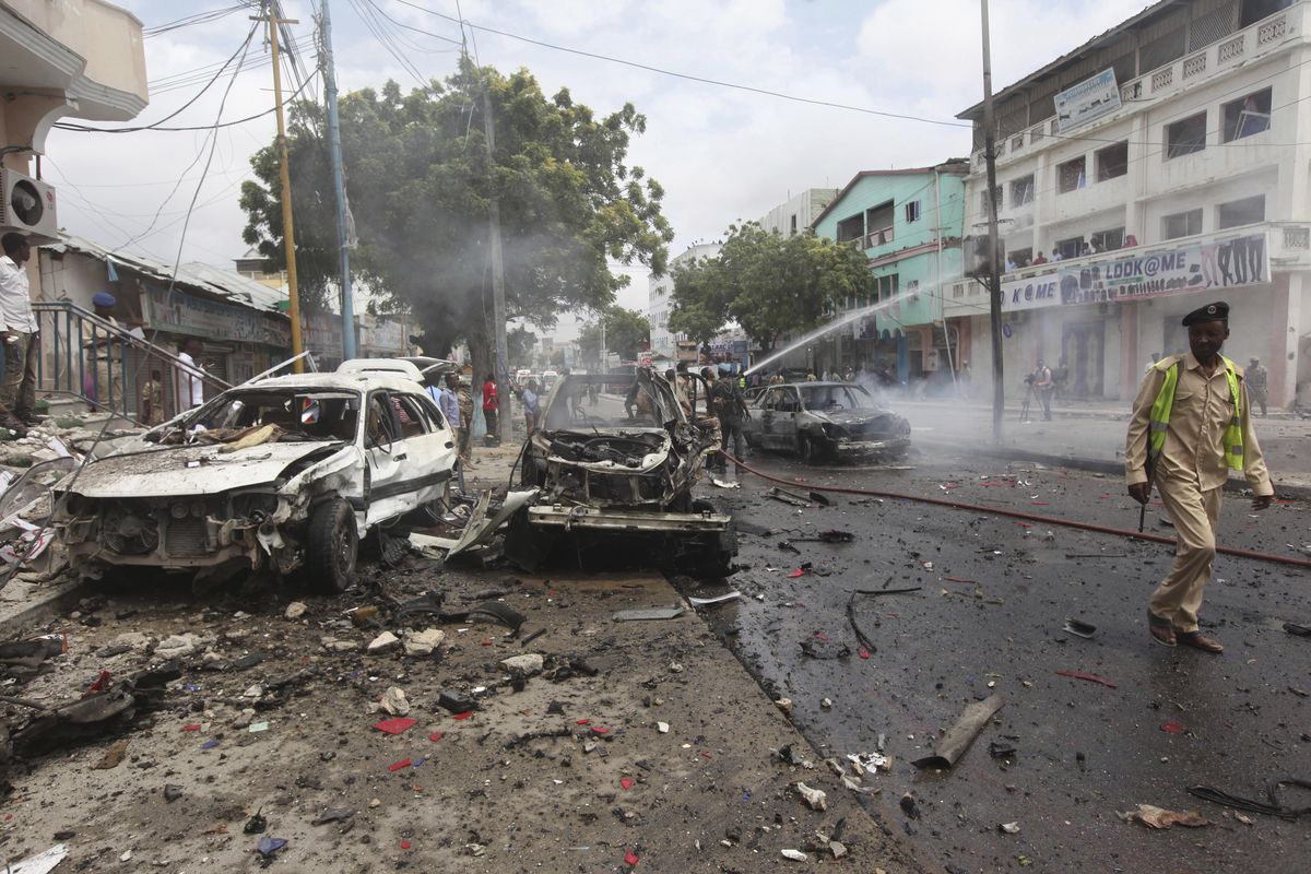 A Somali soldier walks past destroyed cars after a car bomb attack, near a popular mall in Mogadishu, Somalia, Sunday, July 30, 2017. A police officer says a car bomb blast near a police station in Somalia’s capital has killed at least five people and wounded at least 13 others. Most of the victims are civilians. The Somalia-based extremist group al-Shabab often carries out deadly bombings in Mogadishu. (Farah Abdi Warsameh / Associated Press)