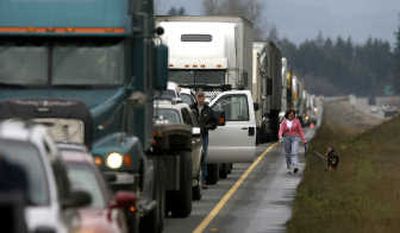
Drivers get out of their vehicles during a  miles-long back-up on southbound Interstate 5 north of Centralia, Wash., on Friday. Associated Press
 (Associated Press / The Spokesman-Review)