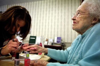 
Ruth Bordenet, 96 , enjoys a manicure Tuesday from Whitworth College freshman Verenise 