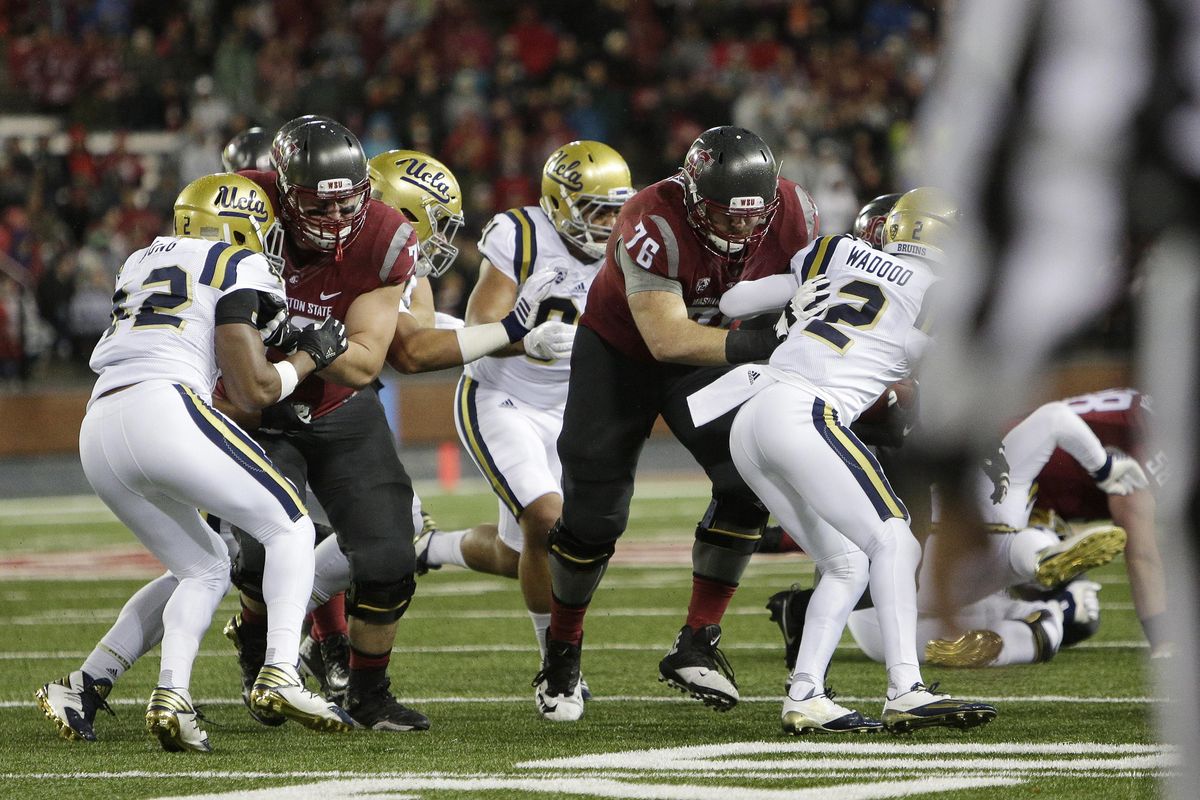 Washington State offensive linemen Cody O’Connell (76) and Eduardo Middleton block against UCLA in the Cougars’ victory last Saturday. (Young Kwak / Associated Press)