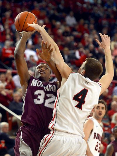 Montana's Kareem Jamar (32), who sent the game to OT with two free throws, scores two of his 28 points. (Associated Press)