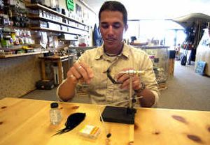 
Sean Visintainer ties a Tungsten Thin Mint fly at the Silver Bow Fly Shop in Liberty Lake. Fly-fishing and fly tying classes are available. 
 (Liz Kishimoto / The Spokesman-Review)