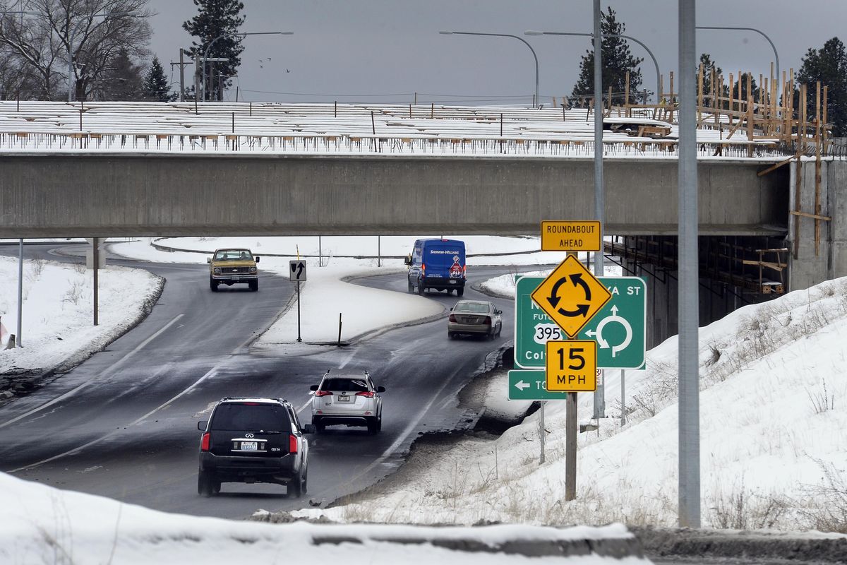 Vehicles pass under then-new North Spokane Corridor bridges along Freya Street on Friday, Feb. 16, 2018. As the gas tax revenues that help fund projects like the corridor decline, the state Department of Transportation may have to delay those projects’ timelines. (Dan Pelle / The Spokesman-Review)