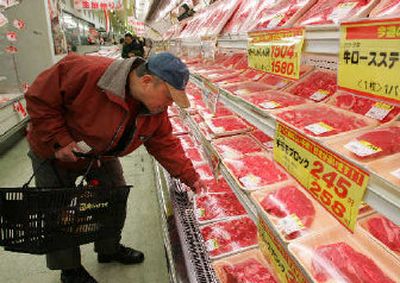 
A shopper at Hanamasa meat wholesale chain looks at a pack of Canadian beef in Tokyo. Japan has agreed to lift its ban on U.S. beef imports, pending planned inspections of U.S. meat processing plants. 
 (Associated Press / The Spokesman-Review)